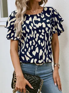 Detailed view of the stylish navy abstract print short sleeve blouse with layered ruffles.