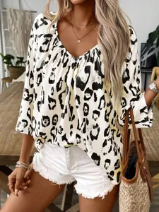 Detailed view of casual V-neck leopard print women shirt, chic everyday commuting styling.