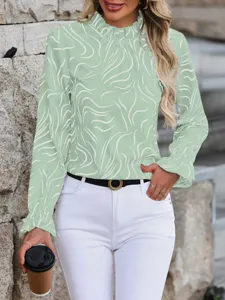 Detail view of a chic light green abstract print long sleeve blouse with ruffled mock neck.