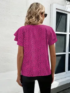 Close-up detail of the vibrant pink abstract print and layered flutter sleeves on the stylish top.