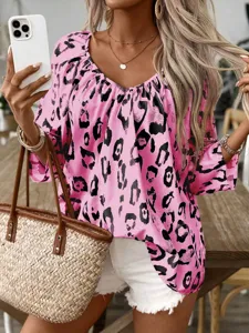 Detailed close-up view of women's pink leopard print V-neck blouse worn with white shorts.