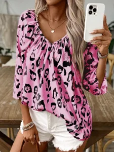Detail view of stylish women's V-neck leopard print blouse showcasing trendy pink pattern.