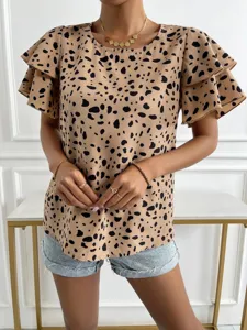 Close-up view of women's short sleeve ruffle blouse with abstract dot print detail.