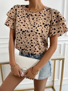 Close-up detail of the beige and black polka dot short sleeve top with stylish layered ruffles.