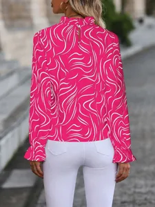 Detailed back view of a hot pink long-sleeve blouse with abstract white lines and ruffles.