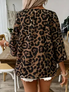 Detail view of a stylish leopard print blouse featuring a relaxed fit and chic design for daily wear.