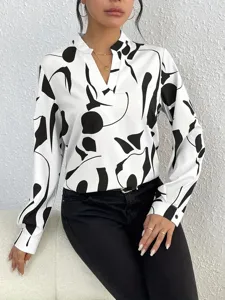 Detailed view of casual black and white abstract print V-neck long sleeve blouse.
