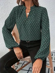 Detailed view of the women's green printed blouse with pleated V-neck and lantern sleeves.
