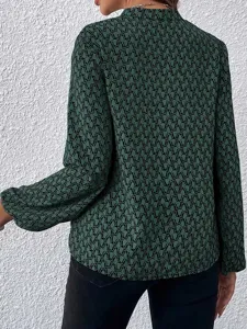 Back detail of elegant green long sleeve blouse with black geometric print and lantern sleeves.