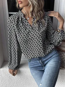 Black and white printed long sleeve blouse with pleated v-neck and lantern sleeves design.
