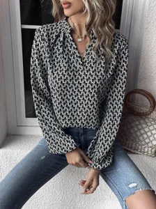 Elegant women's black and white geometric print V-neck long lantern sleeve fashion blouse top.