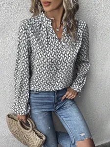 Elegant women's abstract printed long sleeve V-neck lantern sleeve shirt top detail shot.