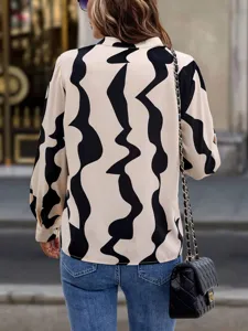 Detail view of the abstract print long sleeve blouse, showing back design and relaxed fit.