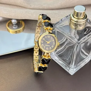 Elegante Damen Quarzuhr Armbanduhr in Goldfarbe mit schwarzem Kleeblatt Design für Damen