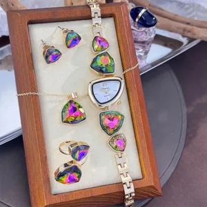 Detailed view of irregular colorful crystal rhinestone watch necklace earrings ring four piece set.