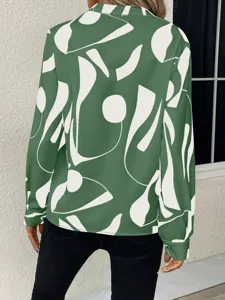 Detail view of the green abstract print long sleeve blouse showing back design and fabric texture.