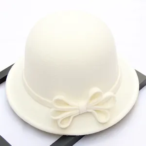Close-up detail of the elegant white wool felt dome hat featuring a stylish side bow design.