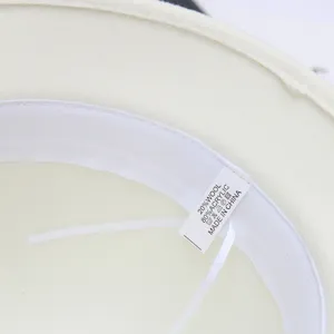 Interior detail shot showing the woolen hat's soft lining fabric and washing label clearly.