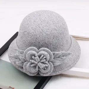 Grey wool felt bucket hat detail, featuring a 3D floral and leaf decoration on the brim.