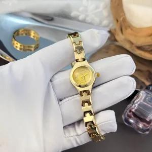 Compact fine strap delicate women watch, classic minimalist quartz watch with small gold dial.