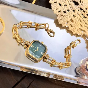 Elegante orologio al quarzo con quadrante verde e bracciale a maglie dorate vintage.