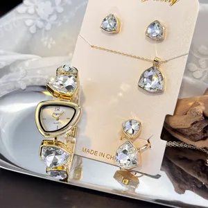 Detail view of the irregular crystal watch necklace earrings and ring set in gold tone.