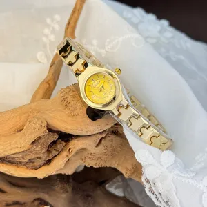 Exquisite small dial gold quartz watch with stylish chain strap for women elegant everyday wear.