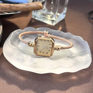 Elegante roségoldene quadratische Quarzuhr mit stilvollem Kabelarmband Detailansicht.