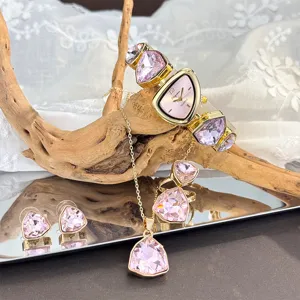 Chic pink crystal jewelry set featuring irregular watch, necklace, rings and sparkling earrings.