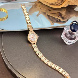 Elegant minimalist quartz watch for women with delicate slender strap and small dial.