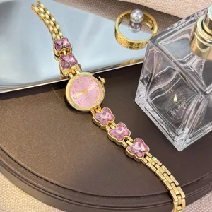 Damen Quarz Uhr goldenes Armband mit rosa Kristall Schmetterling Anhänger Zifferblatt.