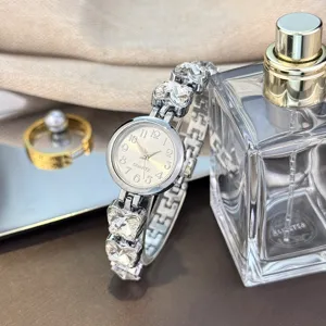 Detailansicht der Damen Quarzmodeuhr mit Kristall Schmetterling Kette und rundem Zifferblatt.