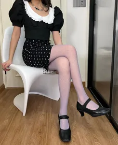 Detailed view of women's sheer patterned tights, argyle mesh hosiery for spring and summer.