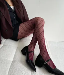 Wine red diagonal stripe hollow jacquard tights detail view, stylish fashion hosiery for women.