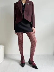Detailed view of stylish women jacquard fishnet tights with diagonal stripe pattern.