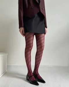 Detail view of women diagonal stripe hollow jacquard fishnet tights anti snag design.