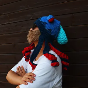 Handmade crochet octopus beanie detail, funny novelty blue and red tentacles hat.