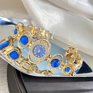 Luxury gold-tone women bracelet watch with blue gemstone and rhinestone bezel dial detail.