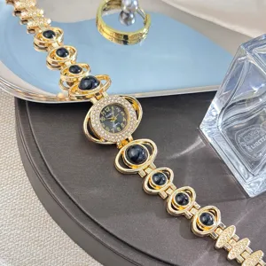 Detailed view of luxury rhinestone star-shaped quartz women bracelet watch with black beads.