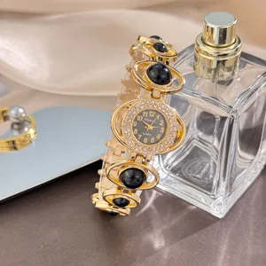 Detailed shot of a luxury women quartz watch with black stones, rhinestone dial, and gold chain.