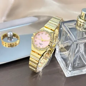 Elegant women's quartz watch with pink dial and rhinestone bezel gold stainless steel bracelet.