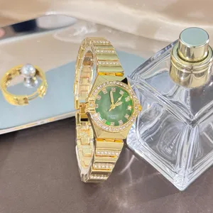 Elegant gold quartz watch with green dial and sparkling rhinestone bracelet for detail.
