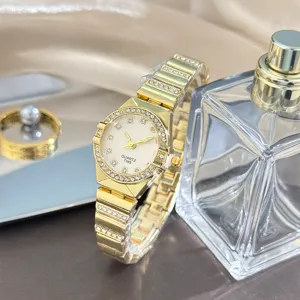 Elegant gold quartz women's watch with sparkling rhinestone bezel and delicate bracelet strap.