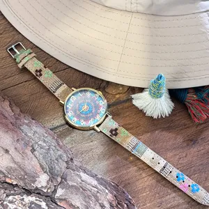 Boho style women quartz watch with colorful canvas strap and vintage mandala dial detail shot.