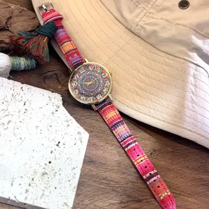 Boho style woven canvas strap women quartz watch with colorful mandala dial detail.