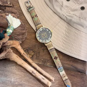 Boho canvas strap watch detail view, vintage tribal quartz wristwatch closeup showing pattern.