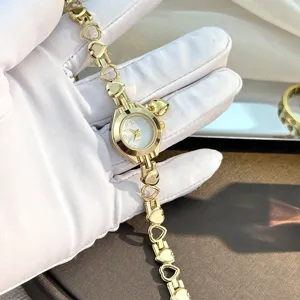 Gold heart chain quartz watch with pendant, elegant jewelry wristwatch for women and girls.