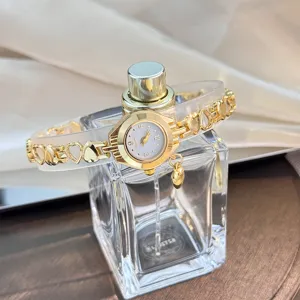 Exquisite women's gold quartz watch with hollow heart chain strap and cute pendant detail.