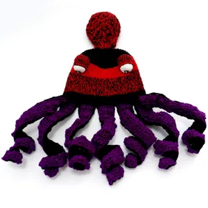 Handmade crochet octopus hat detail, showing intricate red black cap and purple curly tentacles.