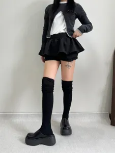 Detailed view of women's knitted knee-high socks featuring vertical stripes, cozy and stylish.